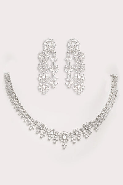 Silver necklace and earrings set on a light gray backgroundSilver necklace and earrings set on a light gray background