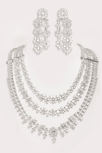 Silver necklace and earrings set on a white backgroundSilver necklace and earrings set on a white background