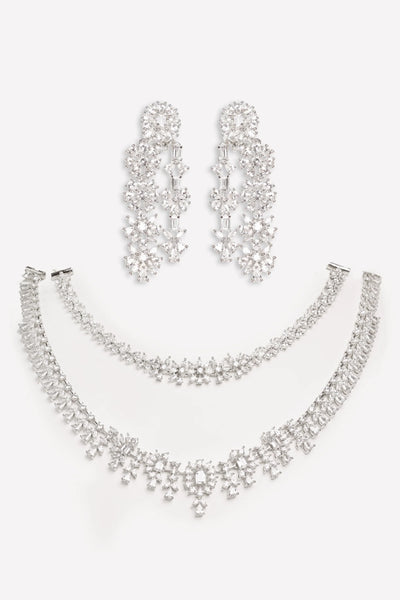 Silver jewelry set with necklace, bracelet, and earrings on a white backgroundSilver jewelry set with necklace, bracelet, and earrings on a white background