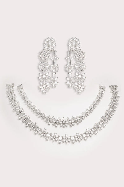 Silver necklace and earrings set on a light gray backgroundSilver necklace and earrings set on a light gray background