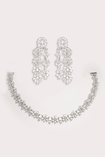 Silver necklace and earrings set on a light gray backgroundSilver necklace and earrings set on a light gray background