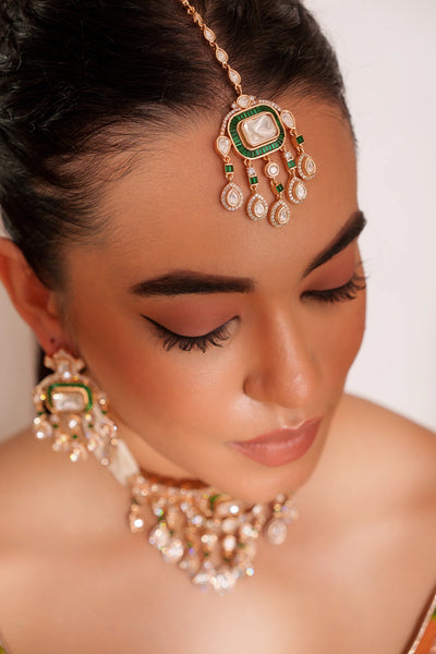 Close-up of a woman wearing traditional kundan jewelry with a white backgroundClose-up of a woman wearing traditional kundan jewelry with a white background