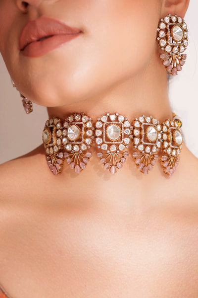 Close-up of a woman wearing ornate gold jewelry with gemstones.Close-up of a woman wearing ornate gold jewelry with gemstones.