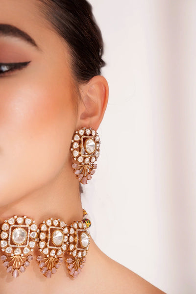 Close-up of a woman wearing ornate earrings with a blurred backgroundClose-up of a woman wearing ornate earrings with a blurred background