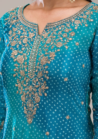 Close-up of a teal embroidered sharara outfit with gold zardosi embroideryClose-up of a teal embroidered sharara outfit with gold zardosi embroidery
