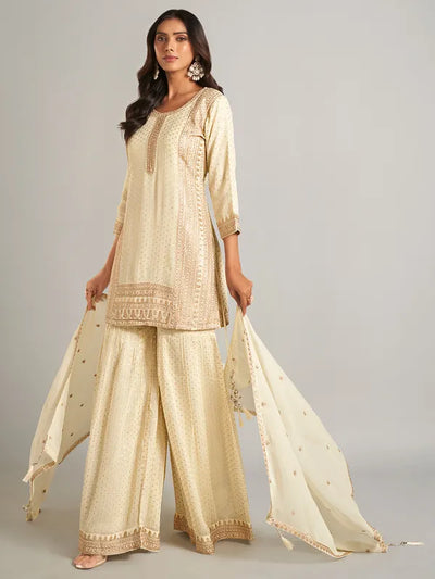 Woman wearing a traditional beige outfit with a plain backgroundWoman wearing a traditional beige outfit with a plain background