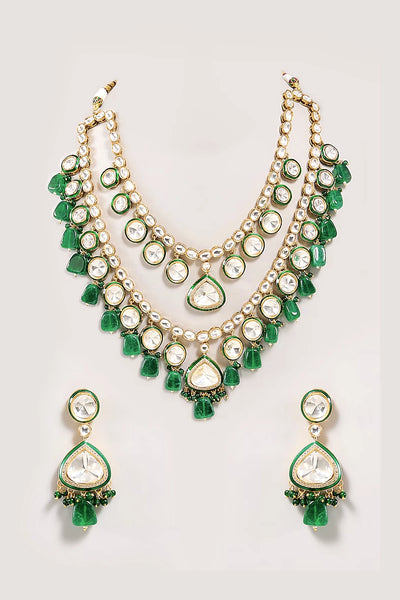 Kundan Polki Green and pearl necklace set on a light gray backgroundKundan Polki Green and pearl necklace set on a light gray background