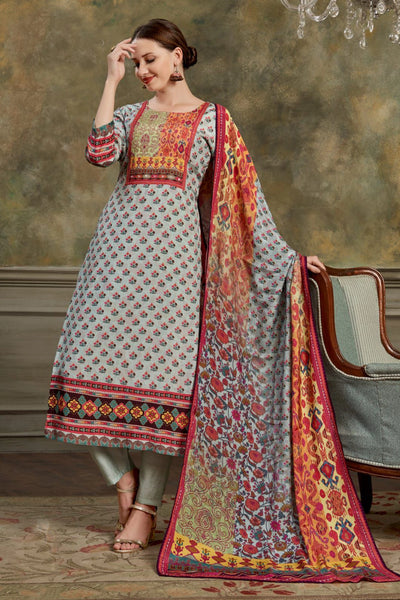 Woman in  Kurta set traditional outfit with a colorful dupatta against a textured wall.