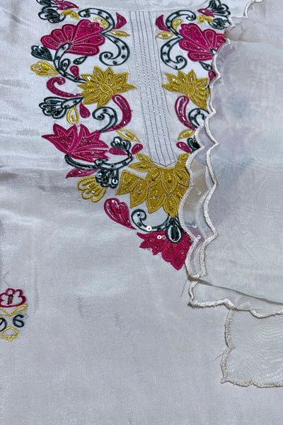 Close-up of embroidered fabric with floral patterns on a white backgroundClose-up of embroidered fabric with floral patterns on a white background