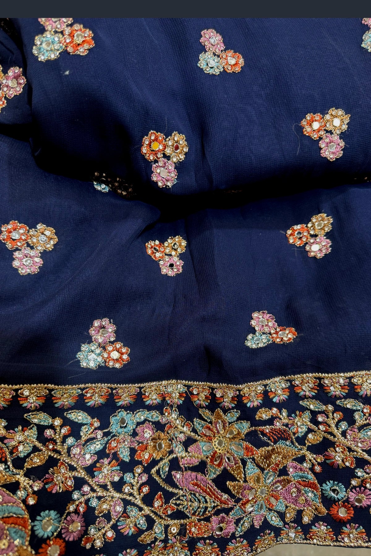 Navy blue georgette fabric with floral embroidery in various colors