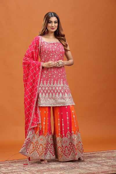 Woman wearing a traditional outfit with a pink and orange design against an orange background