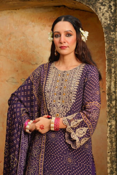 Woman wearing a traditional purple and gold outfit with floral hair accessories against a textured wall.Woman wearing a traditional purple and gold outfit with floral hair accessories against a textured wall.