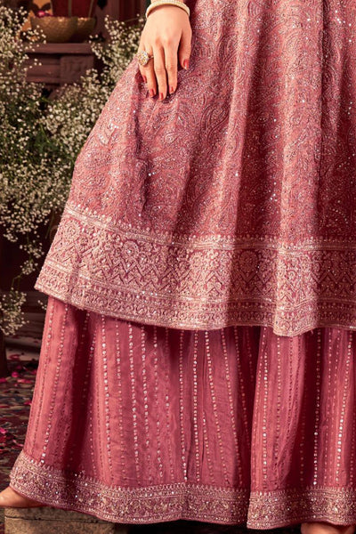 Close-up of a pink embroidered anarkali traditional outfit with a blurred backgroundClose-up of a pink embroidered anarkali traditional outfit with a blurred background