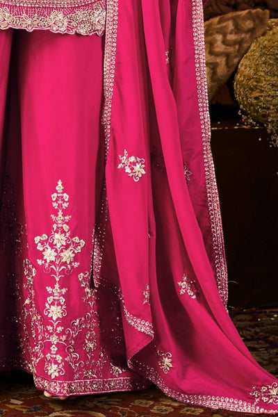 Pink dupatta with intricate white embroidery on a dark backgroundPink dupatta with intricate white embroidery on a dark background